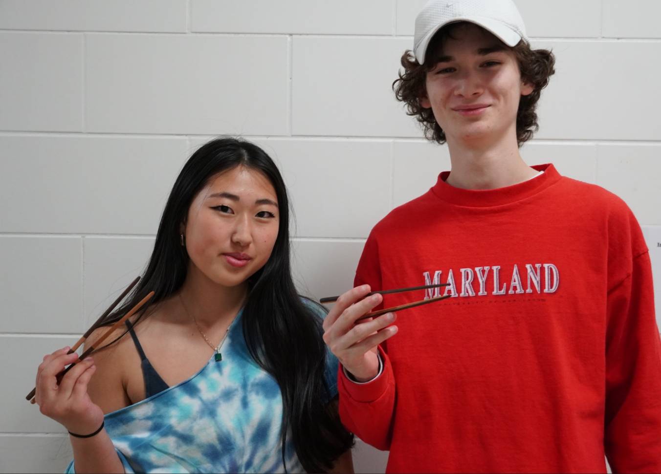 2 Students posing with their handmade chopsticks 